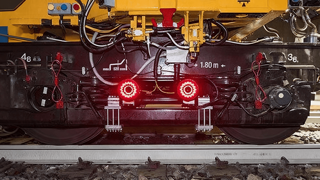 Rail tamping machine operating on live track Rail tamping machine operating on live track